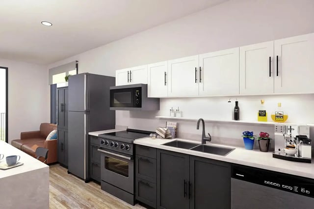 Modern kitchen with stainless steel appliances and brown couch kitchen at Muse Bowling Green in Bowling Green Student Accommodation