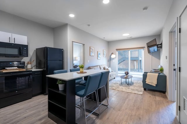 Kitchen dining and living area with modern furniture at Muse Omaha in Omaha Student Accommodation