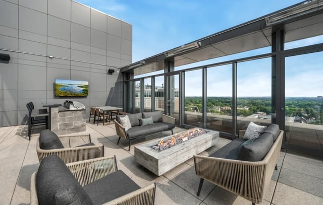 Modern patio with fireplace outdoor dining and seating exterior at Six11 in Ann Arbor Student Accommodation