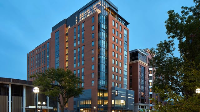 Modern brick building with glass windows exterior at Six11 in Ann Arbor Student Accommodation