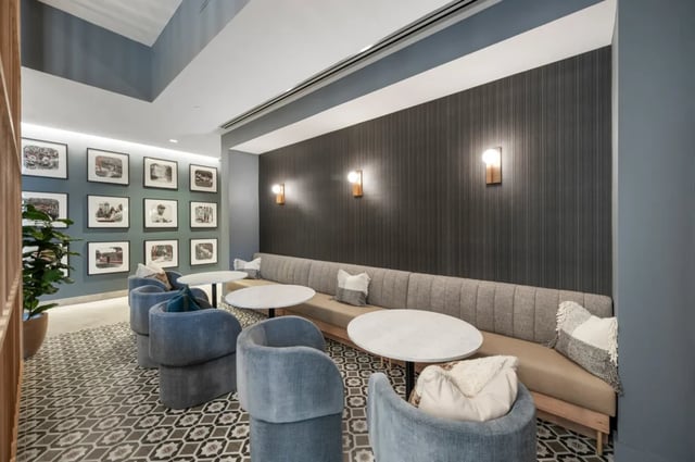 Modern lounge with plush seating and tables at Six11 in Ann Arbor Student Accommodation