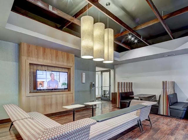 Sofa television booths and tables living room at The Village at Overton Park in Lubbock Student Accommodation