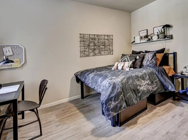 Bed desk chair and bulletin board bedroom at The Village at Overton Park in Lubbock Student Accommodation