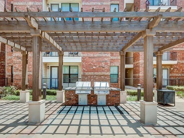 Two stainless steel grills under pergola playing area at The Village at Overton Park in Lubbock Student Accommodation