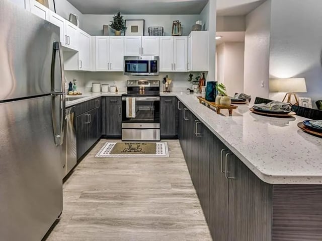 Stainless steel refrigerator white cabinets oven counter kitchen at University Village at Boulder Creek in Boulder Student Accommodation
