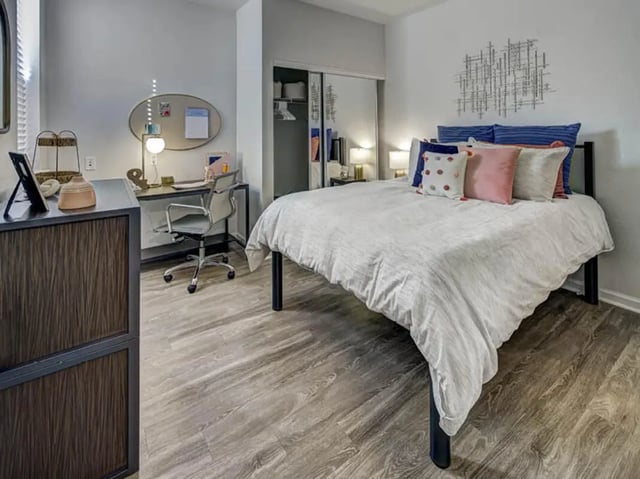Bed desk chair and dresser bedroom at University Village at Boulder Creek in Boulder Student Accommodation