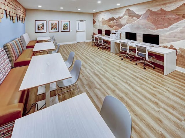 Tables chairs booth seating computers printers study area at University Village at Boulder Creek in Boulder Student Accommodation