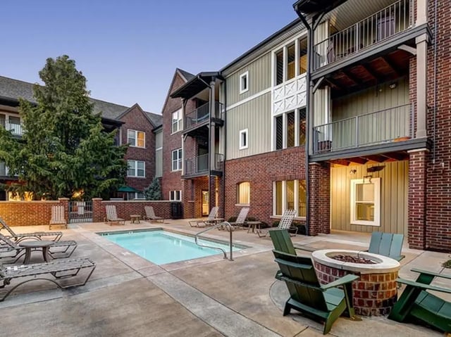Pool lounge chairs and fire pit exterior at The Lodges of East Lansing in East Lansing Student Accommodation