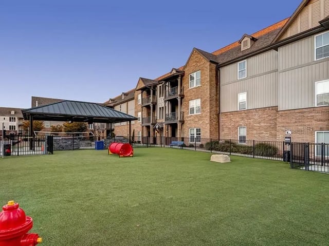 Dog park with agility equipment and volleyball court exterior at The Lodges of East Lansing in East Lansing Student Accommodation