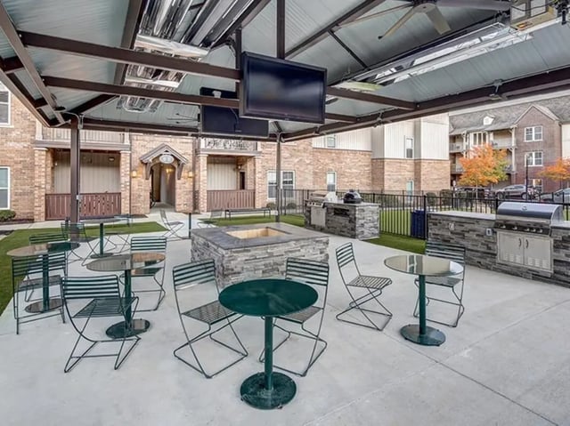Outdoor seating fire pit grills entertainment screens patio at The Lodges of East Lansing in East Lansing Student Accommodation