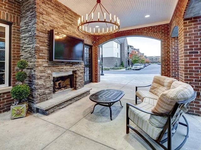 Outdoor living area with fireplace sofa and table exterior at The Lodges of East Lansing in East Lansing Student Accommodation