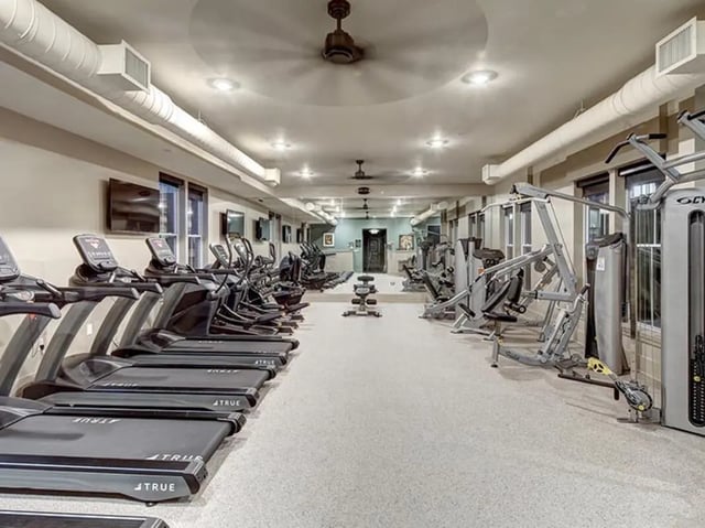 Treadmills ellipticals weight machines gym area at The Lodges of East Lansing in East Lansing Student Accommodation