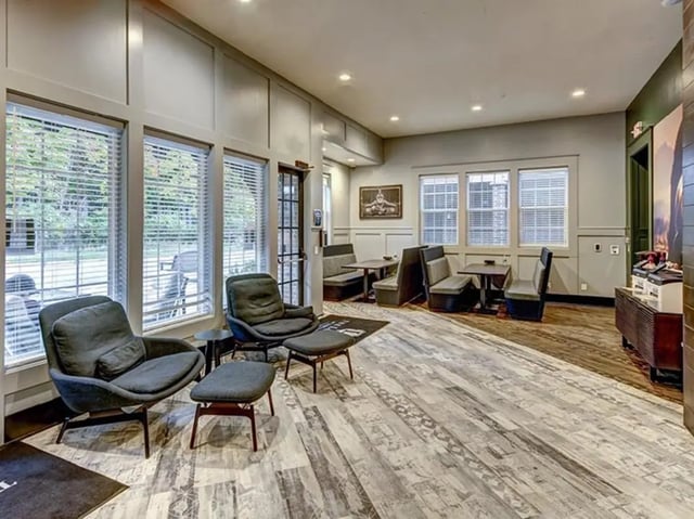 Armchairs ottomans booth seating living room at The Lodges of East Lansing in East Lansing Student Accommodation
