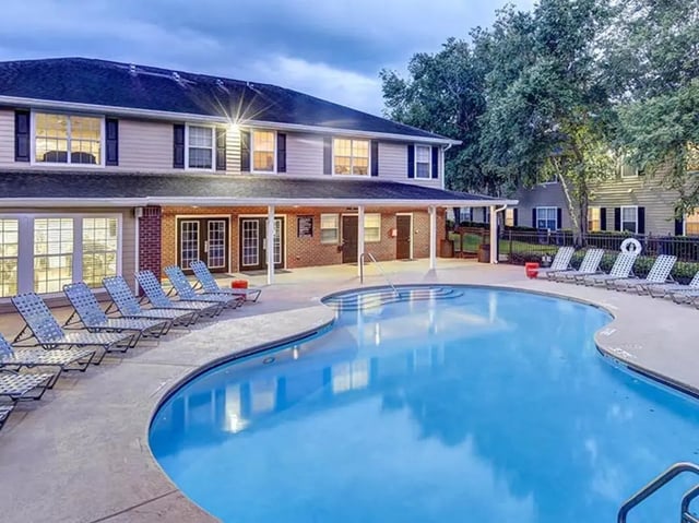 Resort style pool with lounge chairs exterior at University Club Apartments in Gainesville Student Accommodation