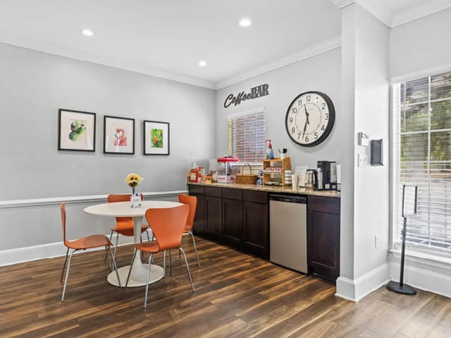 Round table orange chairs coffee bar area kitchen at University Club Apartments in Gainesville Student Accommodation