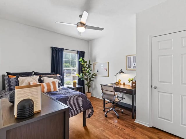 Bed desk and chair in bedroom at University Club Apartments in Gainesville Student Accommodation