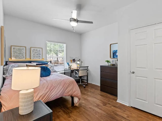 Bed desk lamp and dresser bedroom at University Club Apartments in Gainesville Student Accommodation