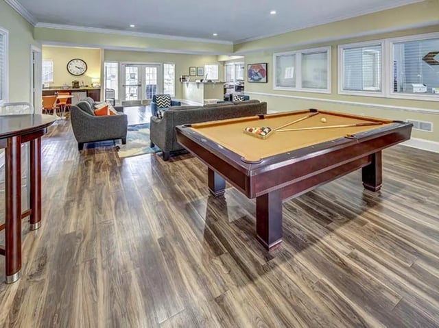 Pool table and seating area living room at University Club Apartments in Gainesville Student Accommodation