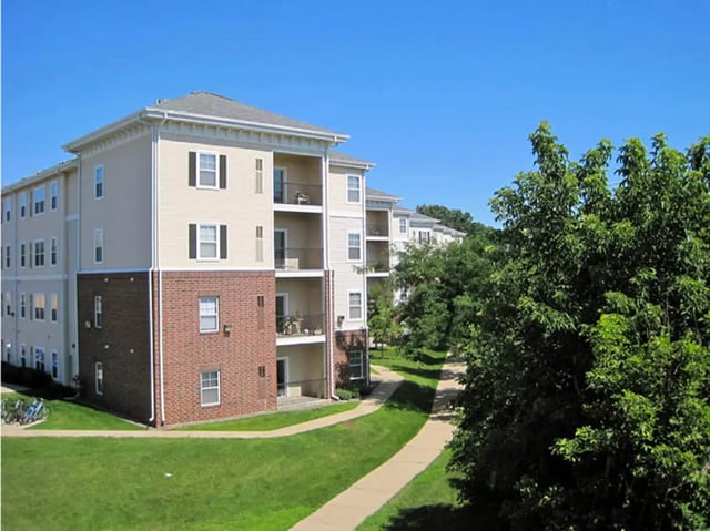 Apartment buildings with balconies and green lawn exterior at University Commons in Minneapolis Student Accommodation