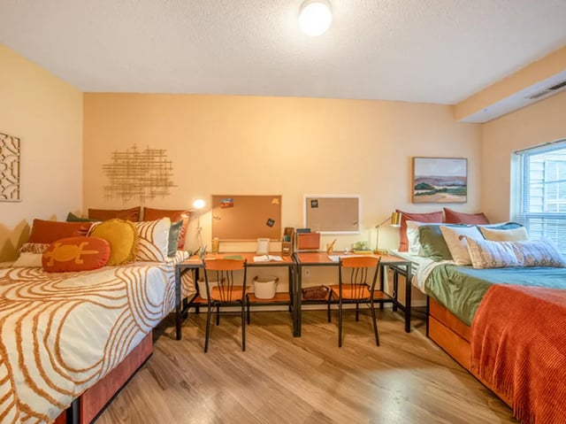 Two beds desks chairs and corkboards bedroom at University Commons in Minneapolis Student Accommodation