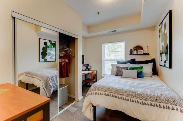 Two beds desk and closet bedroom bedroom at University Commons in Minneapolis Student Accommodation
