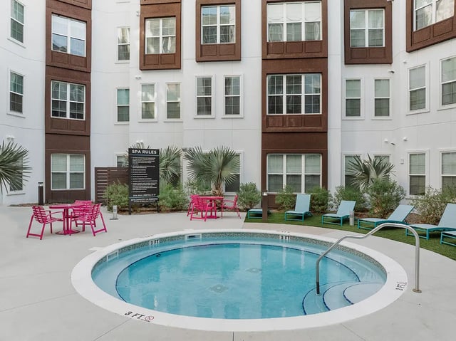 Circular spa with lounge chairs and tables exterior at Current Orlando in Orlando Student Accommodation