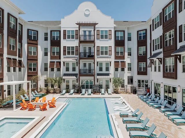 Courtyard with pool lounge chairs and fire pit exterior at Current Orlando in Orlando Student Accommodation