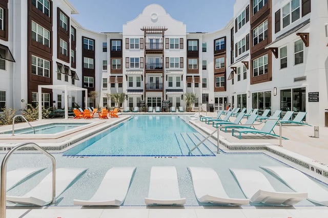Modern apartments with pool lounge chairs and spa exterior at Current Orlando in Orlando Student Accommodation