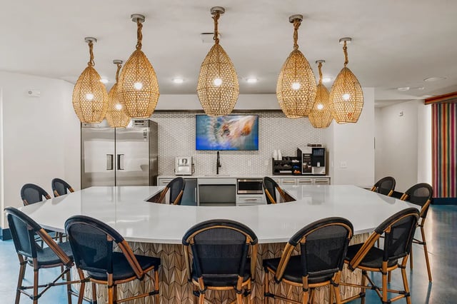 Bar area with stools, refrigerator, and coffee makers kitchen at Current Orlando in Orlando Student Accommodation