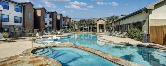 Swimming pool and lounge chairs outdoor area at Villas at Babcock in San Antonio Student Accommodation