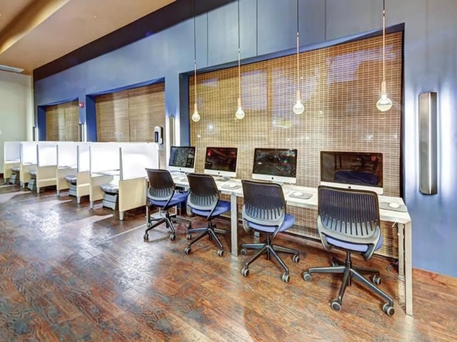 Computers and chairs in study carrels study area at Villas at Babcock in San Antonio Student Accommodation