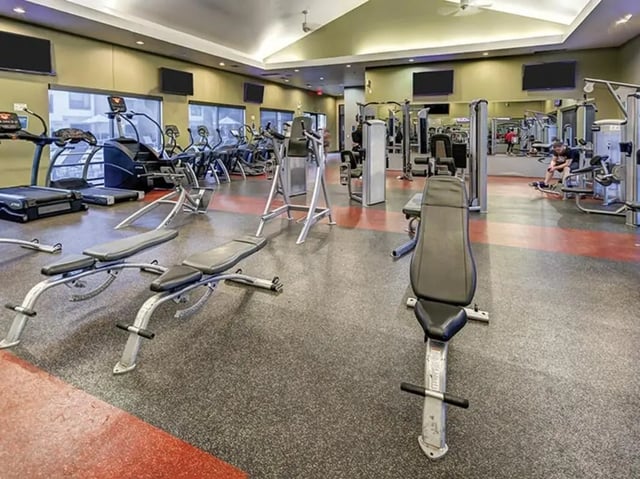 Treadmills weight benches gym equipment fitness area at Villas at Babcock in San Antonio Student Accommodation