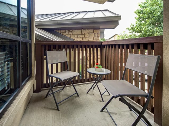 Two chairs and table balcony exterior at Villas at Babcock in San Antonio Student Accommodation