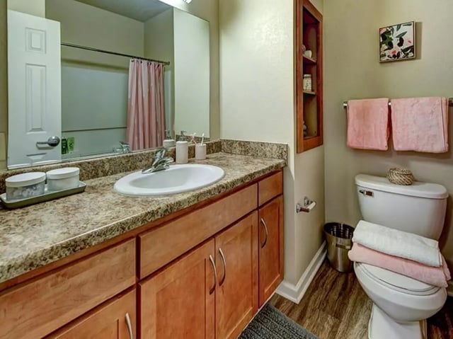 Sink vanity and toilet with towels bathroom at Villas at Chestnut Ridge in Buffalo Student Accommodation