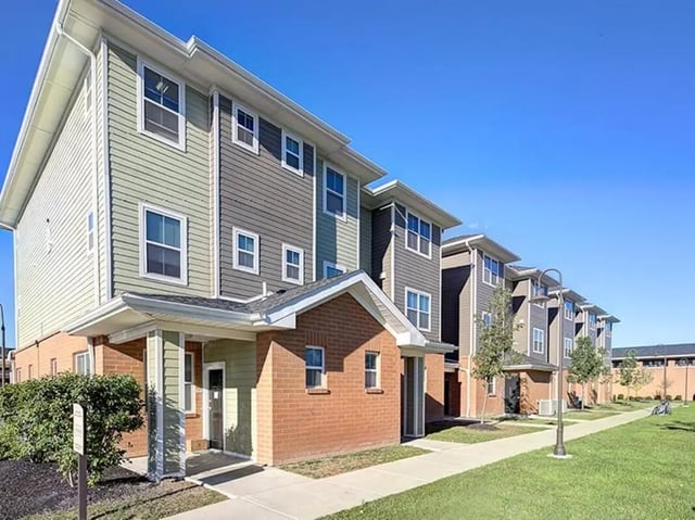 Apartment buildings with brick and siding exterior exterior at Villas at Chestnut Ridge in Buffalo Student Accommodation