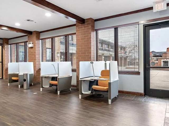 Individual study carrels with orange chairs study area at Villas at Chestnut Ridge in Buffalo Student Accommodation