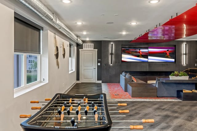 Foosball table large windows sofas televisions communal area at Atlas Athens in Athens Student Accommodation