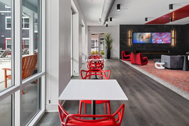 White tables red chairs modern lounge living room at Atlas Athens in Athens Student Accommodation