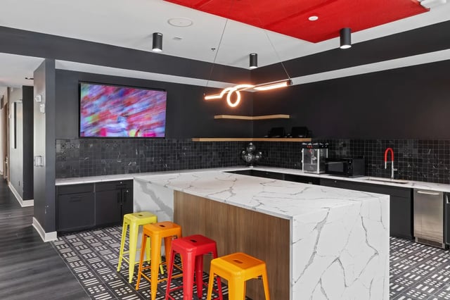 Modern kitchen island with stools and TV kitchen at Atlas Athens in Athens Student Accommodation