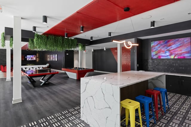 Pool tables bar stools and hanging plants common area at Atlas Athens in Athens Student Accommodation