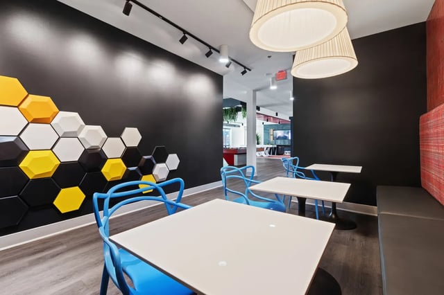Tables chairs honeycomb wall common area at Atlas Athens in Athens Student Accommodation