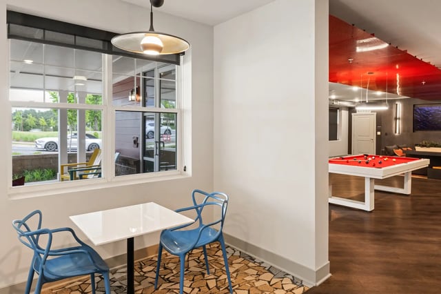 Two blue chairs and table pool table recreation area at Atlas Athens in Athens Student Accommodation