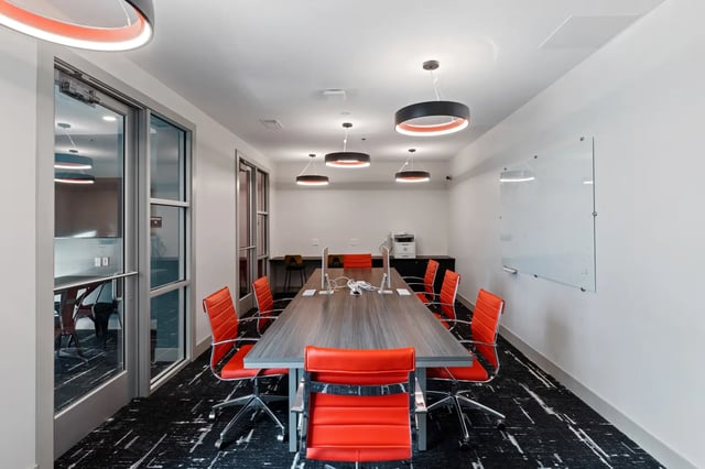 Long table with orange chairs computers printer study room at Atlas Athens in Athens Student Accommodation
