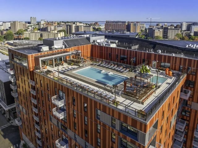 Rooftop pool lounge chairs cabanas exterior view at Atmosphere Madison in Madison Student Accommodation