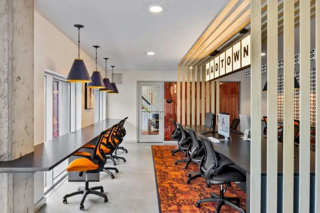 Desk chairs computer monitors orange rug study area at Atmosphere Madison in Madison Student Accommodation