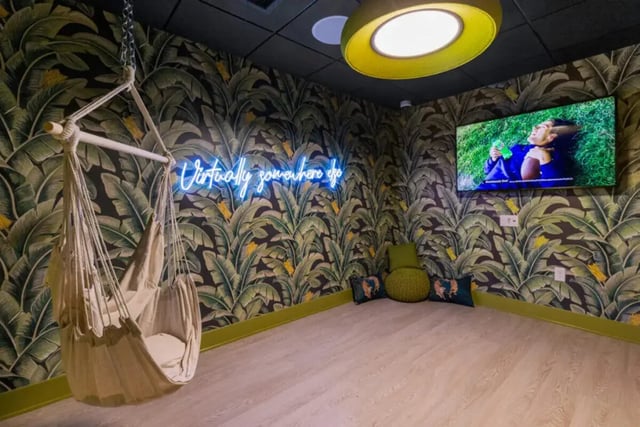 Hammock neon sign television and seating lounge area at Atmosphere Madison in Madison Student Accommodation