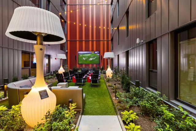 Outdoor cinema area with chairs and large lamps Exterior at Atmosphere Madison in Madison Student Accommodation