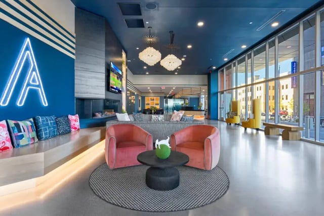 Pink armchairs coffee table fireplace lounge area living room at Atmosphere Madison in Madison Student Accommodation