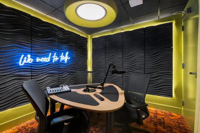 Soundproof room with neon sign and mic setup at Atmosphere Madison in Madison Student Accommodation