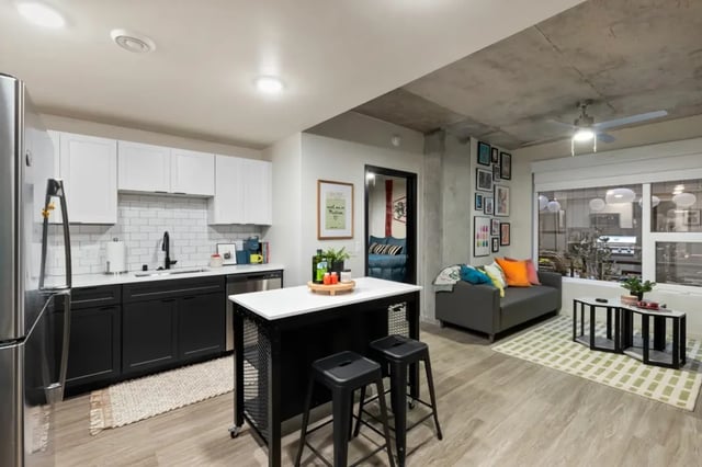 Modern kitchen with island living area and couch living room at Atmosphere Madison in Madison Student Accommodation